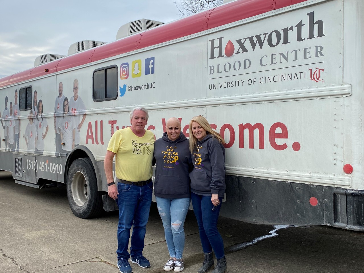 Steph and her parents in front of the Hoxworth donor bus at the #StephStrong blood drive